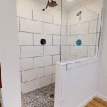 Polished Carera Tile w/ Black Pebble Floor